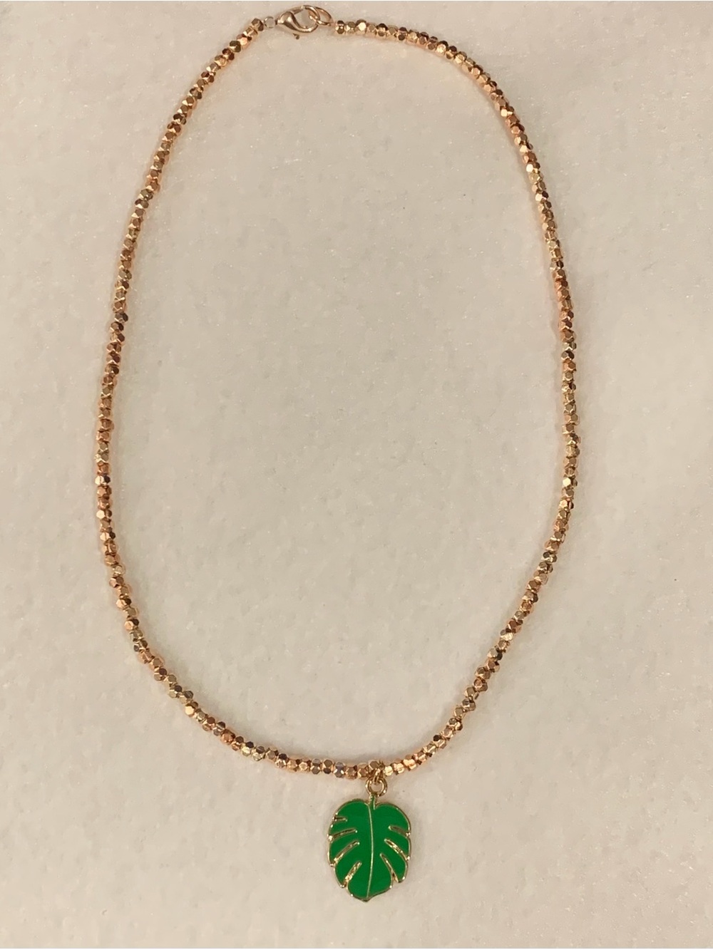 Gold Beaded Necklace with Green Leaf Pendant